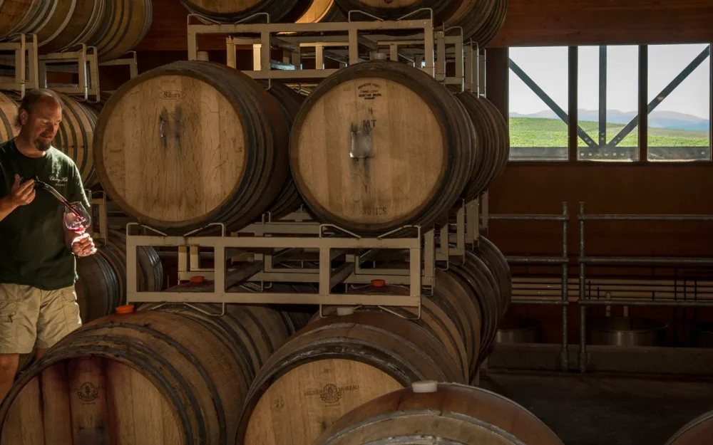 Cherry Hill Winemaker Ken Cook pulling wine from barrel