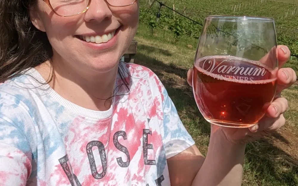 Woman holding a glass of Varnum Vintners wine